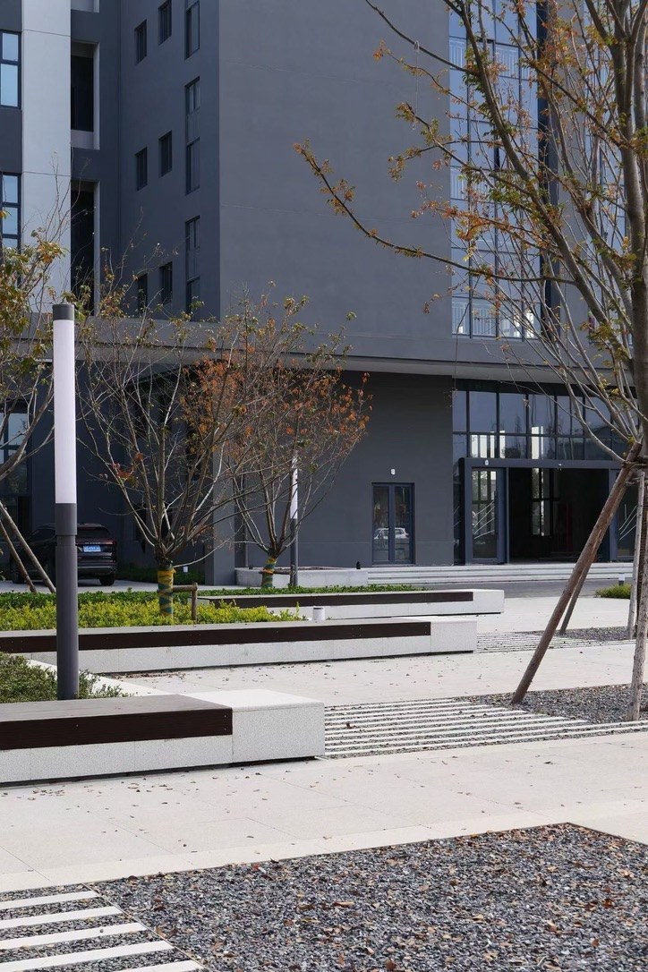 Building entrance and landscaped seating at the new MEGEE campus